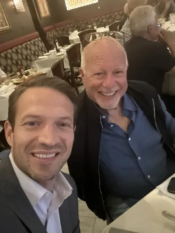 Bruce Elia Jr. celebrating a closed real estate deal with a happy client